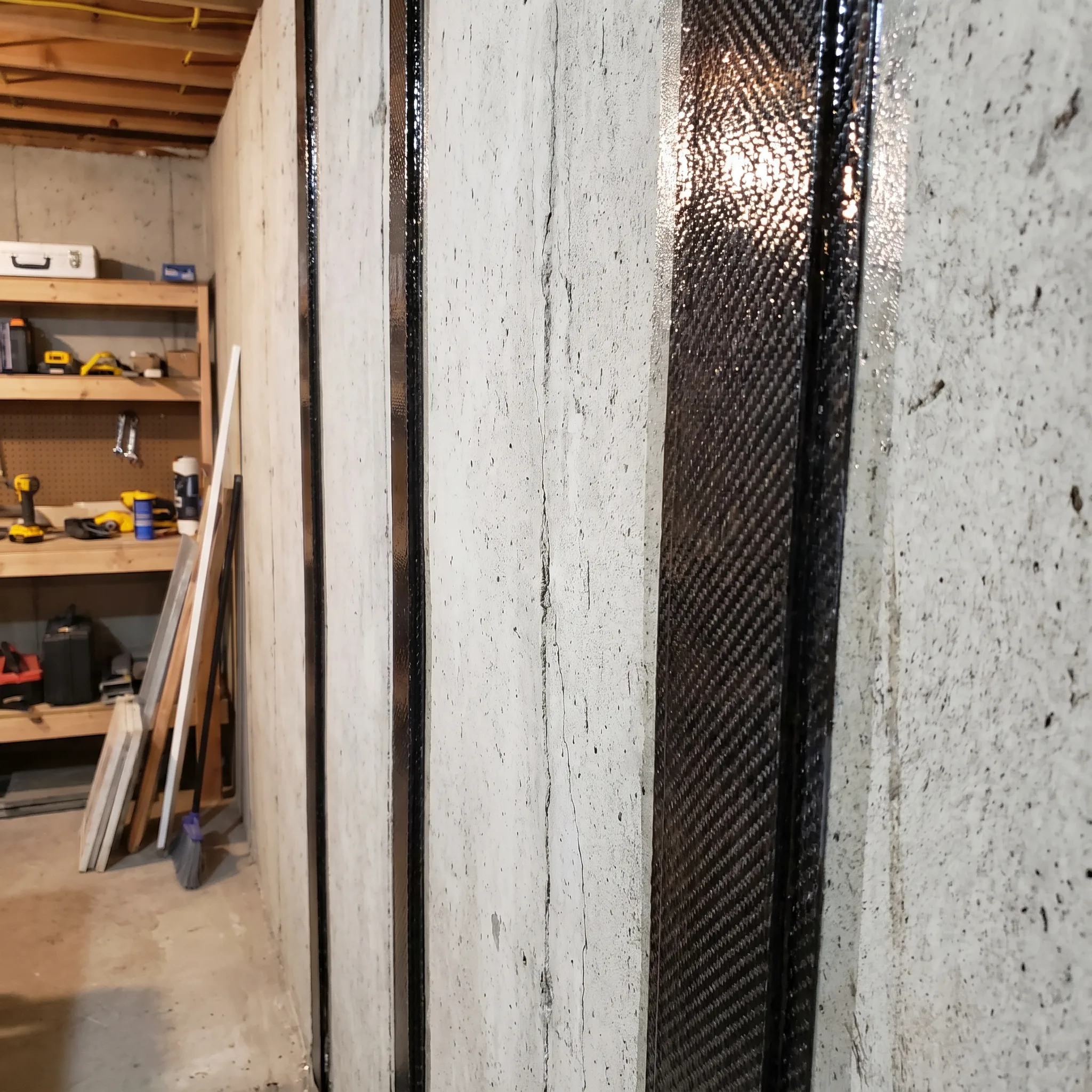 Carbon fibre wall reinforcement installation on a bowing foundation wall in Strathcona, Hamilton