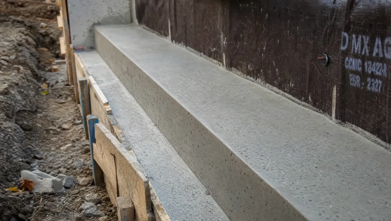 Bench footings Hamilton - concrete ledge bench being formed along foundation wall