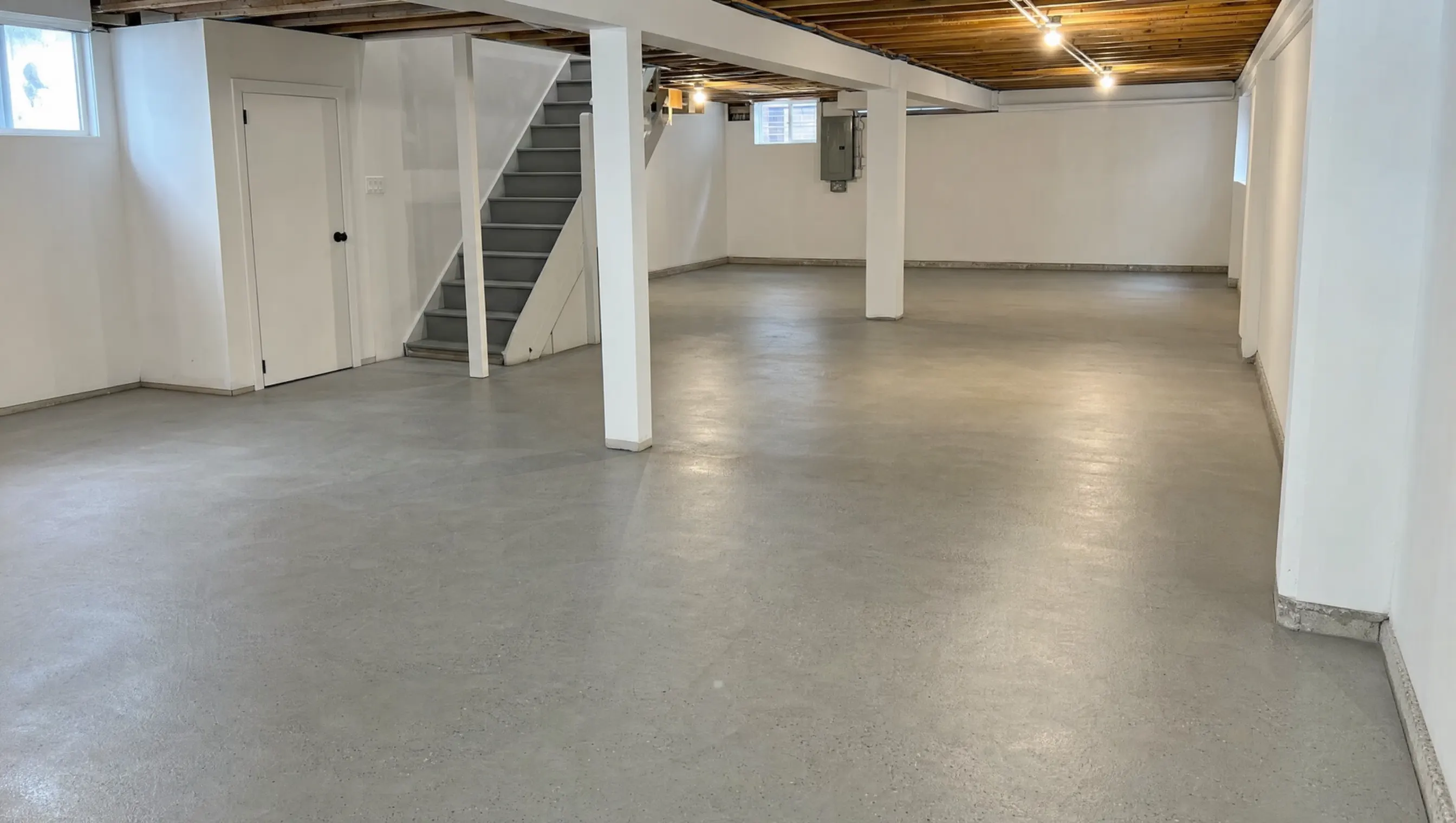 Concrete floor replacement hamilton - smooth finished slab in bright basement
