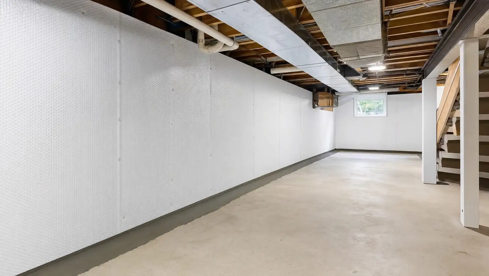 Interior waterproofing Hamilton - dry finished basement after drainage system installation